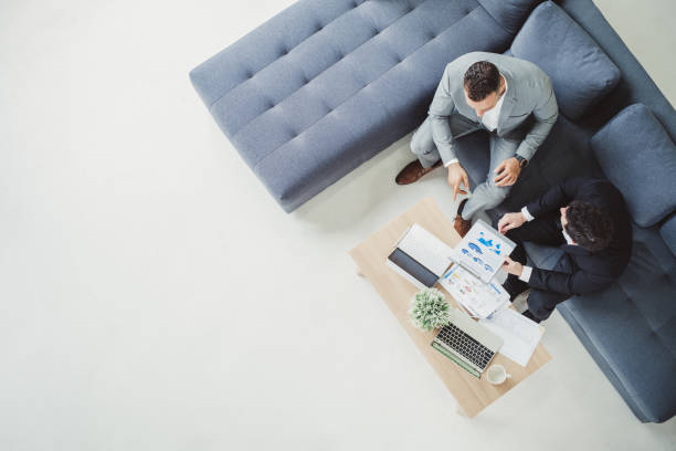 istock Two business man discussing work on table in office, top view 1002033594