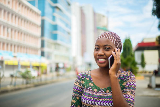 istock Beautiful Smiling Young confident African girl talking on mobile phone looking at camera 1002033608