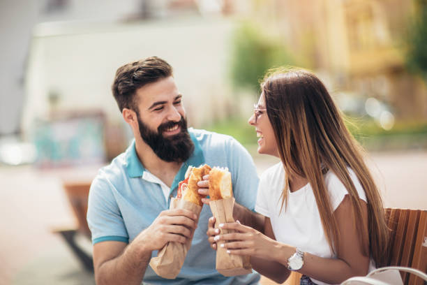 istock Young couple is eating sandwiches and having a great time 1002036284