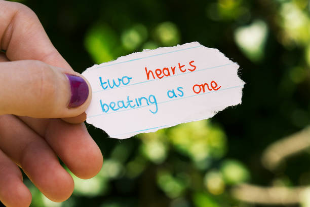 istock Female hand holding cute hand-written love note 1002036894