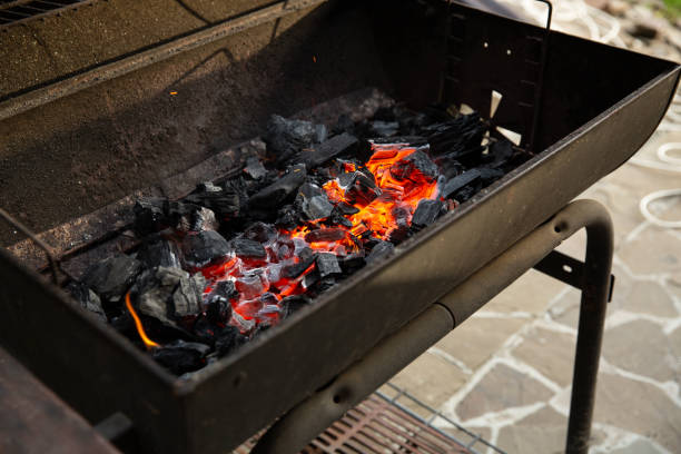 istock Metal barbecue grill with burning charcoal inside ready for grilling 1002036908