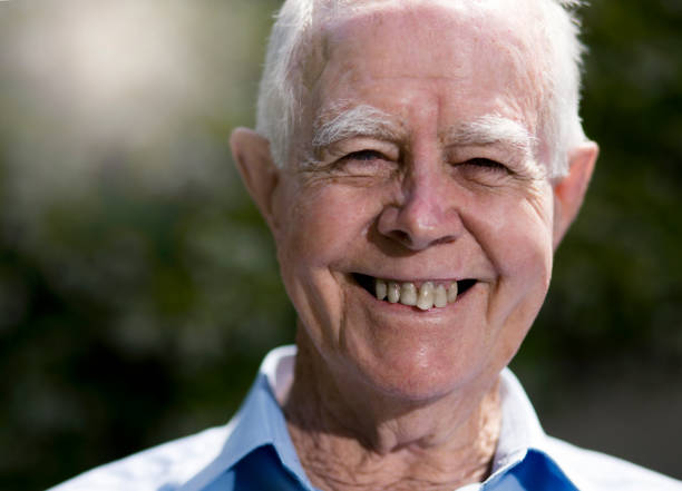 istock Smiling senior man in sunlit garden 1002042620