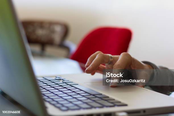 Hand Of Woman On Touch Pad Of Silver Color Laptop Working From Home Stock Photo - Download Image Now