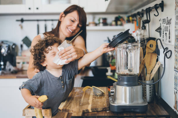 istock Mother helping son to blow his nose 1002049968