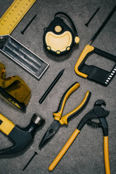 istock top view of hammer, hacksaw, pliers and tools on grey surface 1002054010