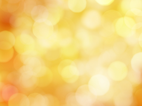 Abstract Soft Glowing Golden Yellow Background with Bokeh Lights