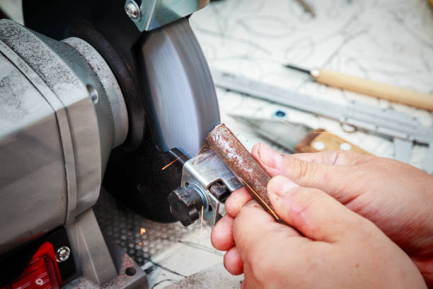 istock Sharpening the steel billet on the grinding machine 1002057896