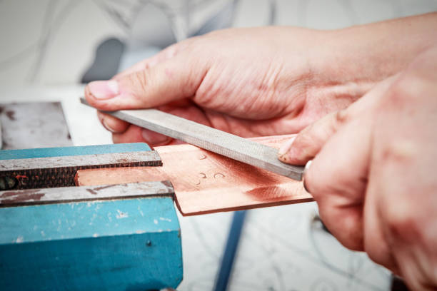 istock Grinding the copper billet with a file 1002058618