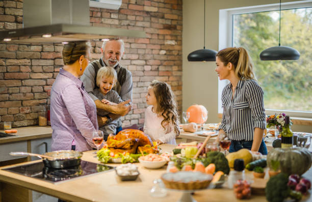 istock Happy multi-generation family preparing Thanksgiving dinner in the kitchen. 1002060930