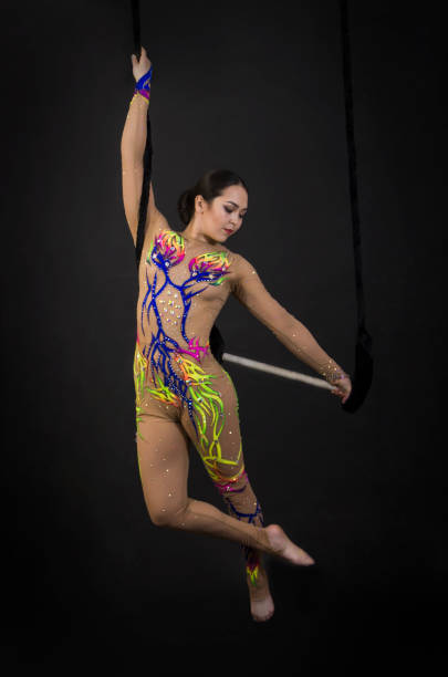 istock A young girl performs the acrobatic elements in the air trapeze. 1002061296