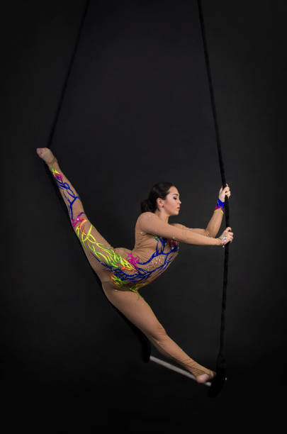 istock A young girl performs the acrobatic elements in the air trapeze. 1002061336