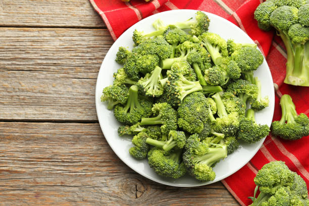 istock Broccoli in plate with napkin on grey wooden table 1002061566
