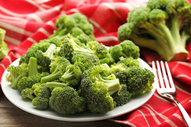istock Broccoli in plate with napkin on grey wooden table 1002062188