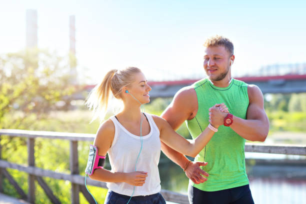 istock Young couple jogging in park 1002062284