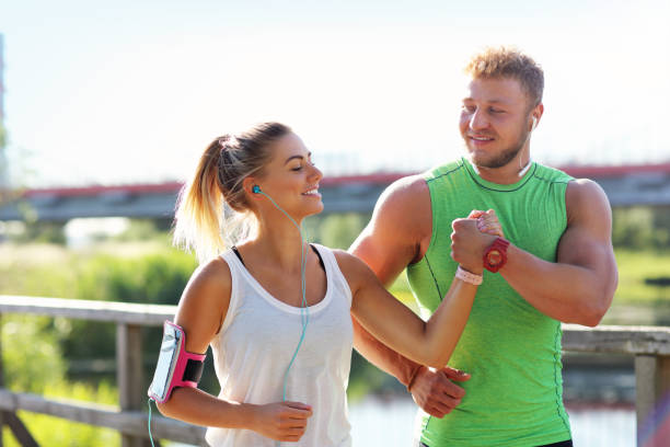 istock Young couple jogging in park 1002064522