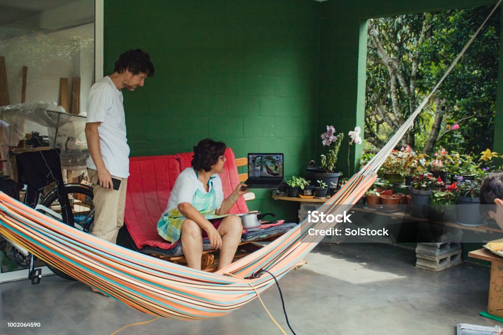 Family In Latin America Casually Connecting With Family Over The Internet Home environment with family through skype Cali - Colombia Stock Photo