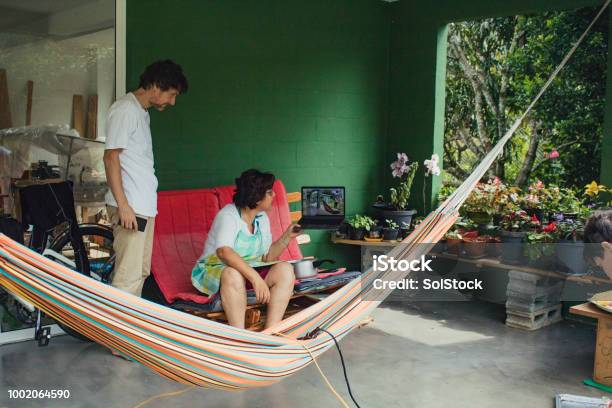Family In Latin America Casually Connecting With Family Over The Internet Stock Photo - Download Image Now