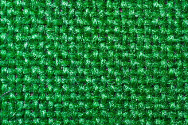 istock Textile background of bright green tweedy fabric 1002064740