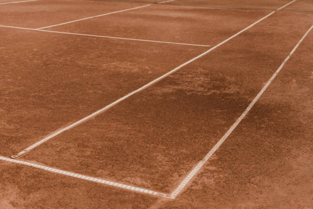 istock brown tennis court with white marking lines 1002065010