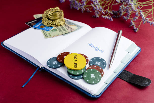 istock Open notebook with word Budget, poker chips, pen and dollar mone 1002065364