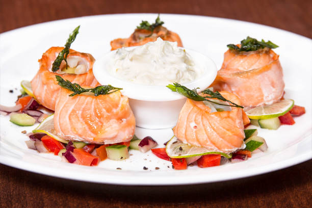 istock Rolls from a salmon with vegetables and white sauce. 1002066204