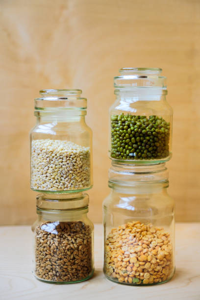 istock Beans, peas, wheat and pearl barley in jars 1002066310