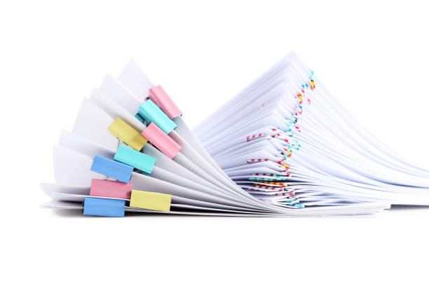 istock Stack of papers with paperclips and clamps on white background 1002068930