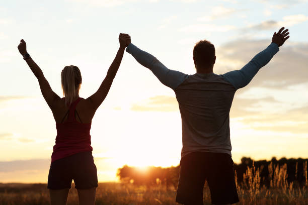 istock Young couple jogging in the suberbs after sunset 1002072112