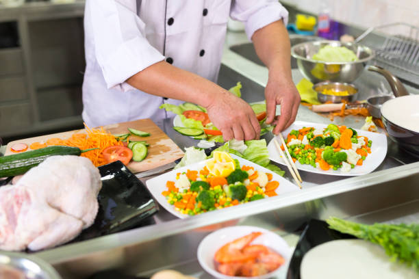 istock Senior chef decorating salad in asian restaurant 1002072554