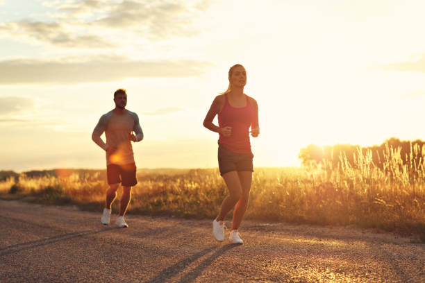 istock Young couple jogging in the suberbs after sunset 1002072882