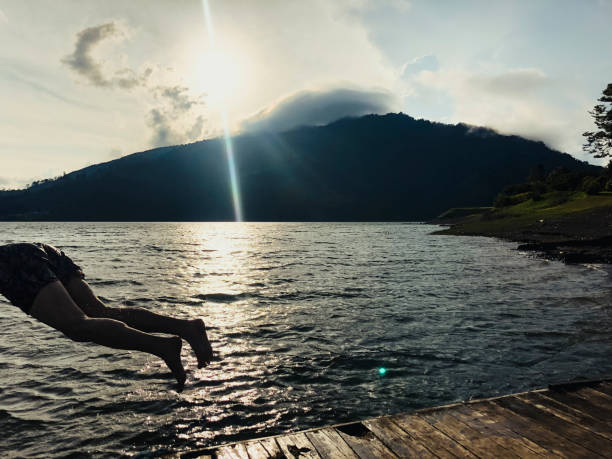 istock Man Diving Into Lake Calima At Sunset 1002072886