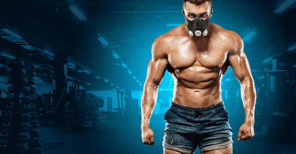 istock Brutal strong muscular bodybuilder athletic man pumping up muscles on gym background. Workout bodybuilding concept. Copy space for sport nutrition ads. 1002072982