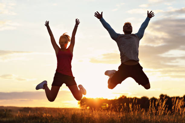 istock Young couple jogging in the suberbs after sunset 1002075220