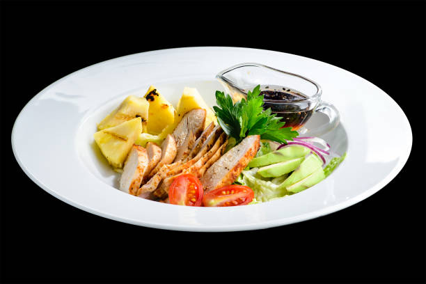 istock Appetizing delicious chicken with pineapple, avocado, tomato and 1002076348