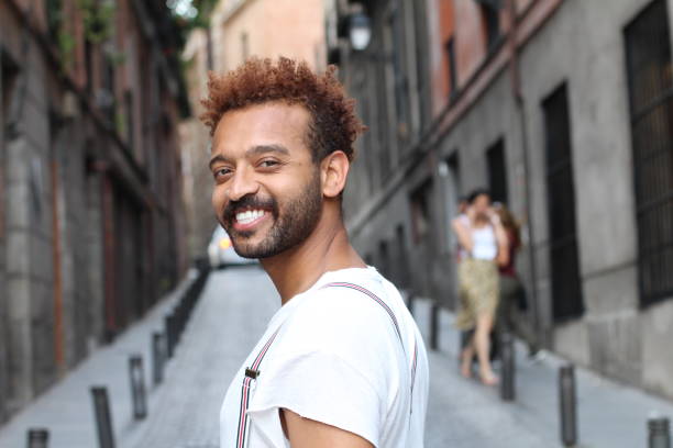 istock Brazilian man smiling on the street 1002076480