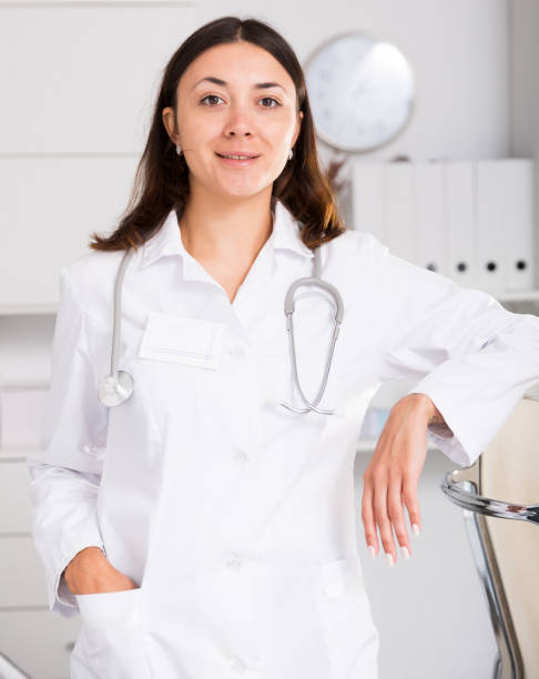 istock Young  female practitioner in white uniform standing in clinic's office 1002079178