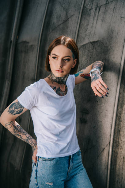 istock attractive stylish woman with tattoos posing and looking away 1002079366