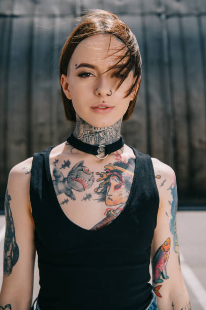 Portrait Of Young Attractive Woman With Tattoos Looking At Camera Stock  Photo - Download Image Now - iStock