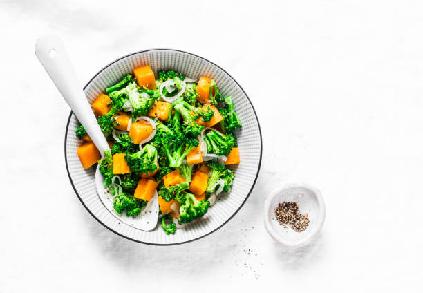 istock Broccoli, pumpkin warm salad  on a light background, top view. Copy space 1002080012