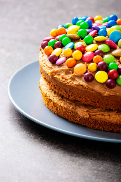istock Colourful candy on top of chocolate cake 1002082994