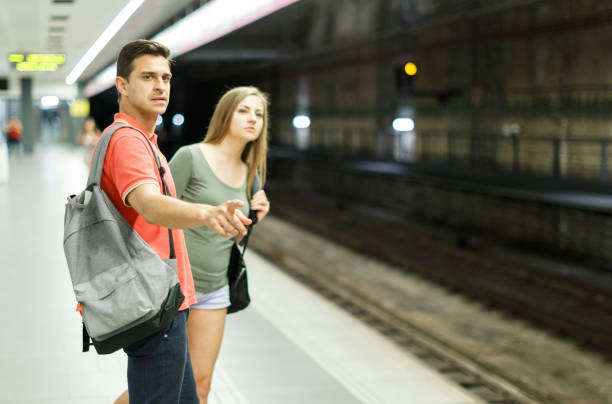 istock Man with his girlfriend are standing on platform and waiting train 1002086474