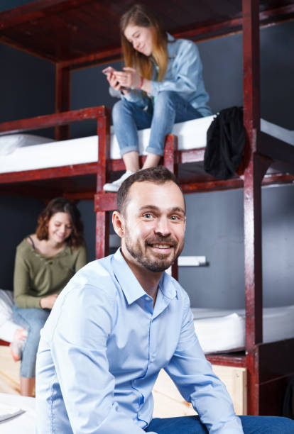 istock Ssmiling male traveller in hostel 1002086822