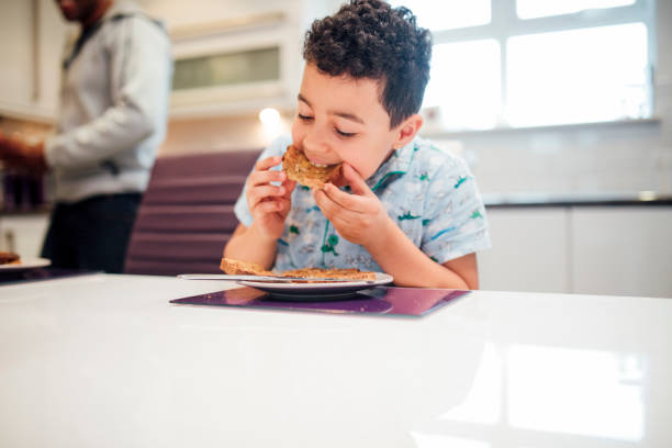 tucking in to toast for breakfast - butter toast bread breakfast imagens e fotografias de stock