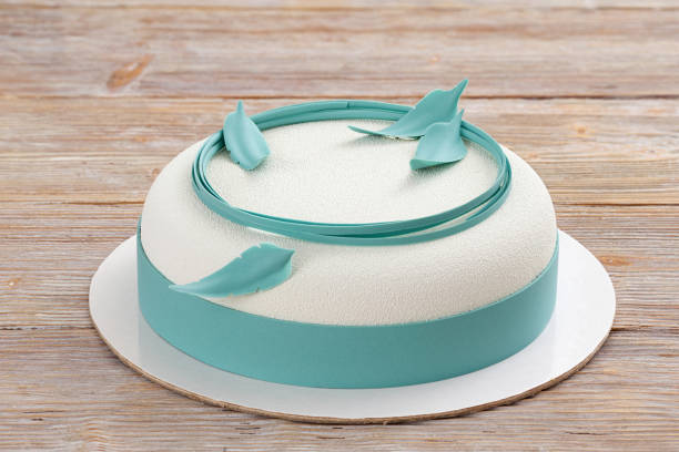 istock white mousse cake on wooden background closeup 1002087436