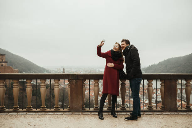 istock Young tourists taking photos wile exploring Heidelberg 1002090478