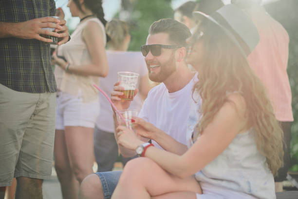 istock Couple sitting at outdoor party. 1002091512
