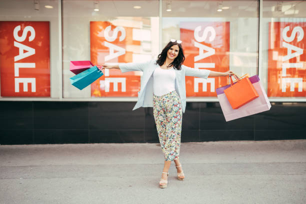 istock Happy young woman having fun while shopping 1002103330