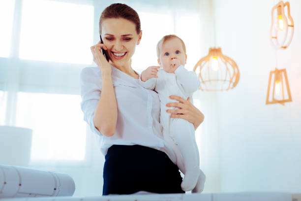 istock Positive delighted mommy working at home 1002104242