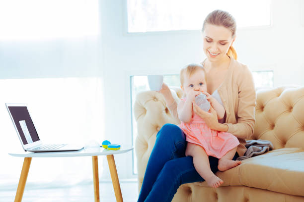istock Happy young woman looking at her child 1002106988