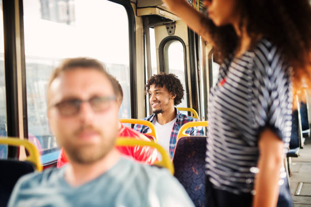 istock Charming Afro-American man is looking through the bus window and smiling. 1002107360